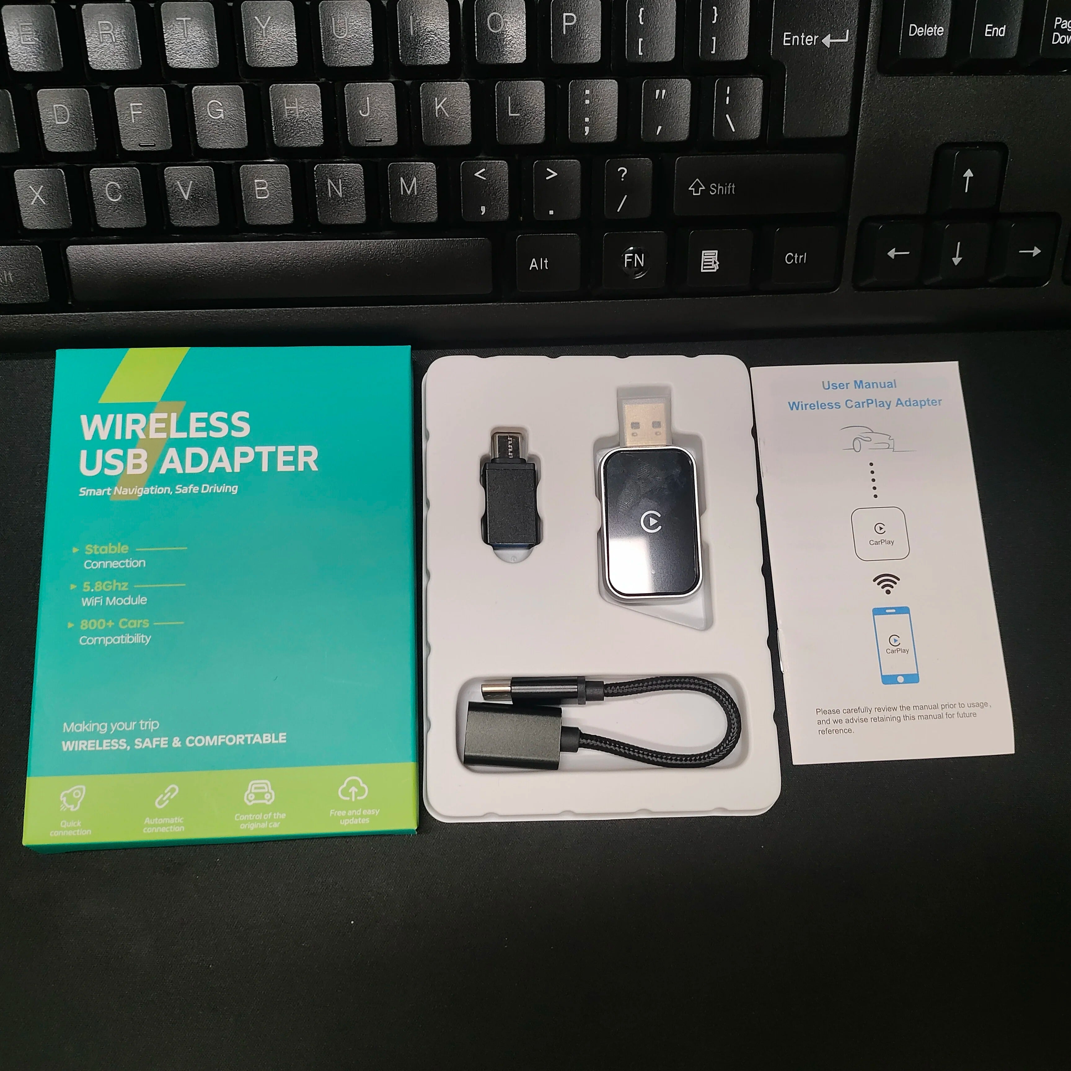 Wireless USB adapter with packaging and manual on a desk